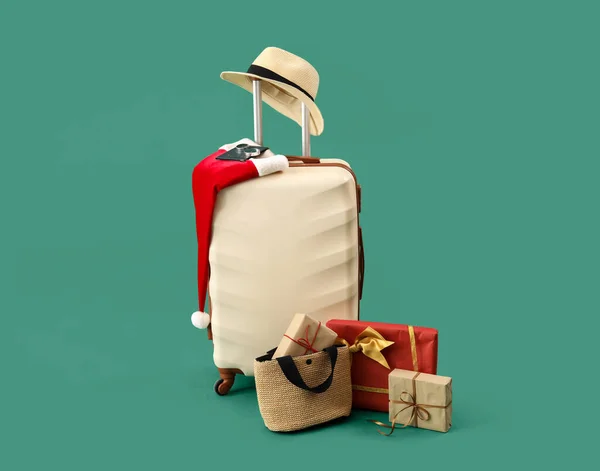 Suitcase Santa Hat Christmas Gifts Travel Accessories Green Background — Stock Photo, Image