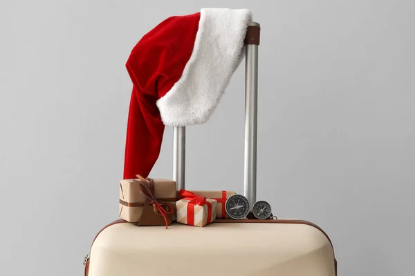 Suitcase Santa Hat Christmas Gifts Compasses Grey Background — Stock Photo, Image