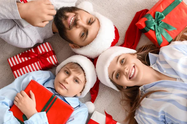 Happy Parents Little Son Santa Hats Christmas Gifts Lying Floor — Stock Photo, Image