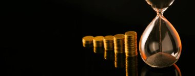 Kum saati ve bozuk paralar koyu arkaplanda ve mesaj için yer var. Vakit nakittir.