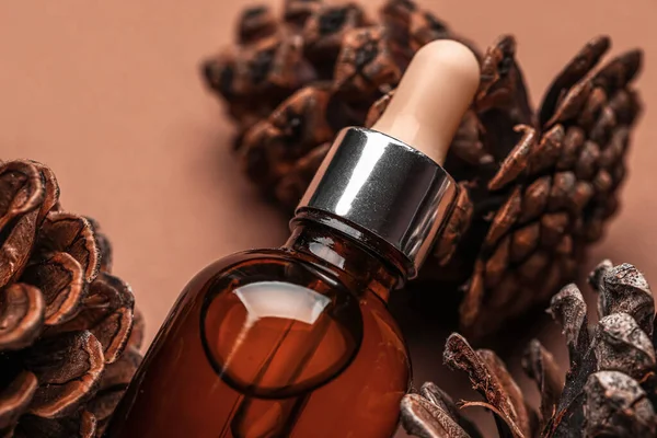 Bottle Essential Oil Pine Cones Brown Background Closeup — Stock Photo, Image