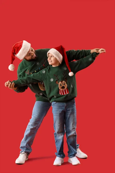 Mutlu Baba Küçük Oğlu Kırmızı Arka Planda Noel Baba Şapkaları — Stok fotoğraf