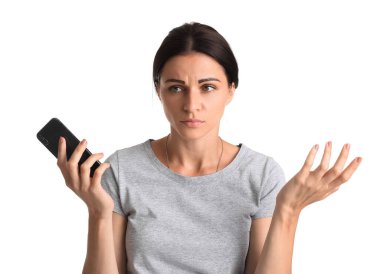 Beyaz arka planda cep telefonu tutan stresli genç bir kadın.