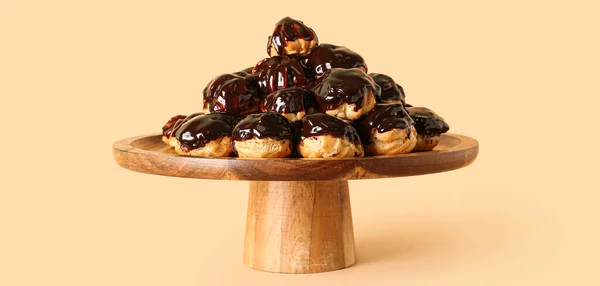 Wooden Dessert Stand Delicious Profiteroles Beige Background — Stock Photo, Image