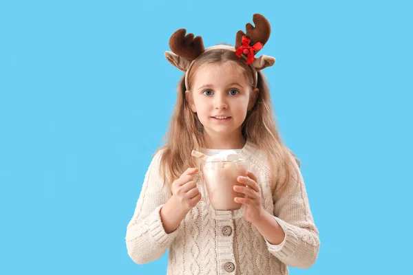 Little Girl Reindeer Horns Holding Cup Cocoa Marshmallows Blue Background — Stock Photo, Image
