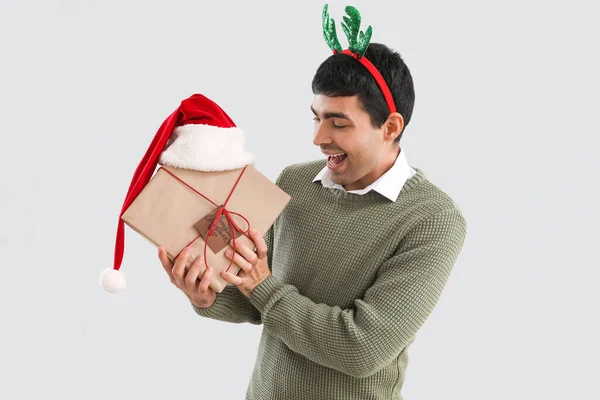 Young Man Reindeer Horns Christmas Gift Santa Hat Grey Background — Stock Photo, Image