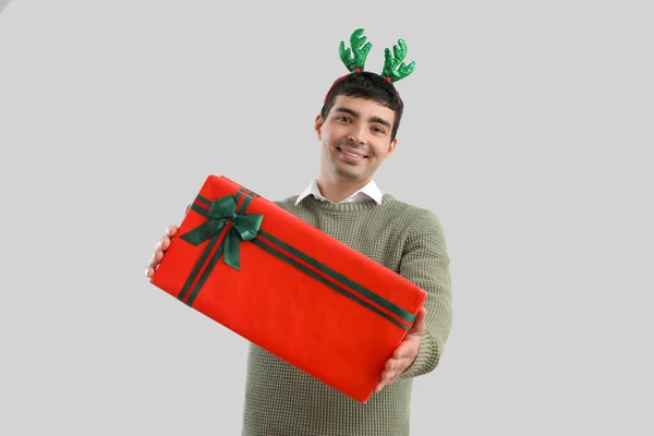 Young Man Reindeer Horns Christmas Gift Grey Background — Stock Photo, Image