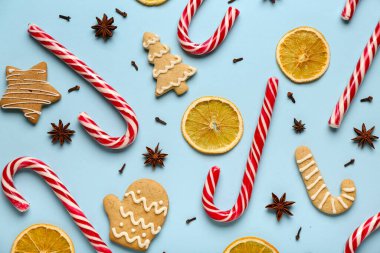 Lezzetli şeker kamışları, kurabiyeler, baharatlar ve arkaplanda kurutulmuş portakal dilimleri olan kompozisyon