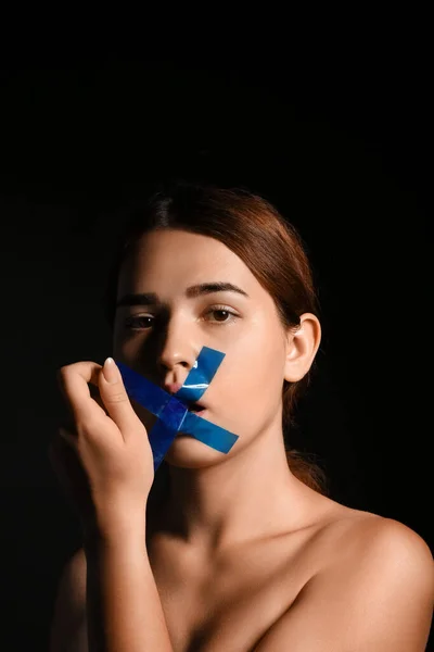 Young Woman Removing Tape Mouth Dark Background Censorship Concept — Stock Photo, Image