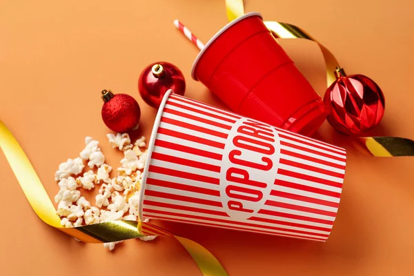 Bucket Popcorn Ribbons Cup Christmas Balls Orange Background — Stock Photo, Image