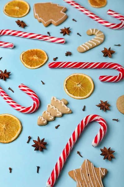 stock image Composition with tasty candy canes, cookies, spices and dried orange slices on color background