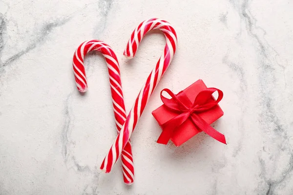 甘いキャンディーの杖と光の背景のクリスマスプレゼント — ストック写真