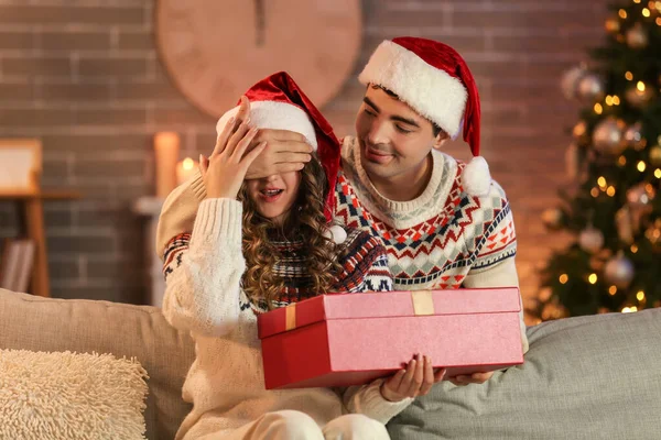 Young Man Surprising His Beloved Girlfriend Present Home Christmas Eve — Stock Photo, Image