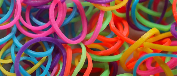 Many colorful rubber bands, closeup view