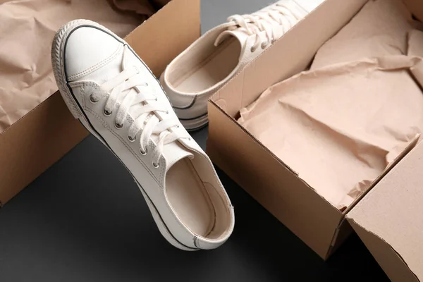 Cardboard Boxes White Sneakers Dark Background Closeup — Stock Photo, Image