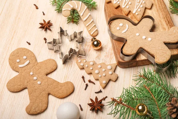 stock image Tasty Christmas cookies, cutters and fir branches on wooden background