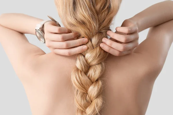 Blonde Woman Naked Back Adjusting Pigtail Hairstyle Light Background — Stock Photo, Image