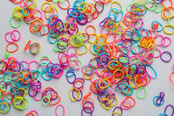Many different office rubber bands on white background