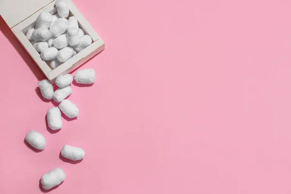 stock image Box with cotton balls on pink background