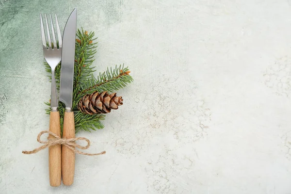 stock image Cutlery with fir branch and pine cone for Christmas celebration on grunge background