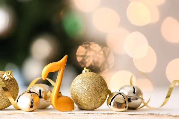Note Sign Balls Bells Table Blurred Christmas Lights — Stock Photo, Image
