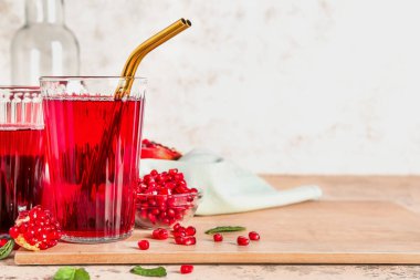 Masada taze nar suyu bardaklarıyla ahşap tahta.