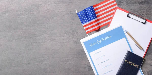 Banner with visa application form, documents and USA flag on table. Concept of immigration