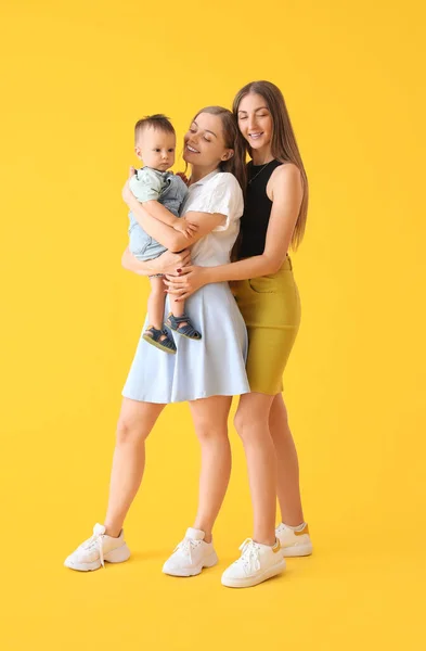 Happy Lesbian Couple Little Baby Yellow Background — Stock Photo, Image