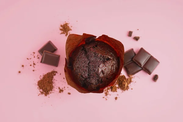 Stock image Delicious chocolate muffin on pink background