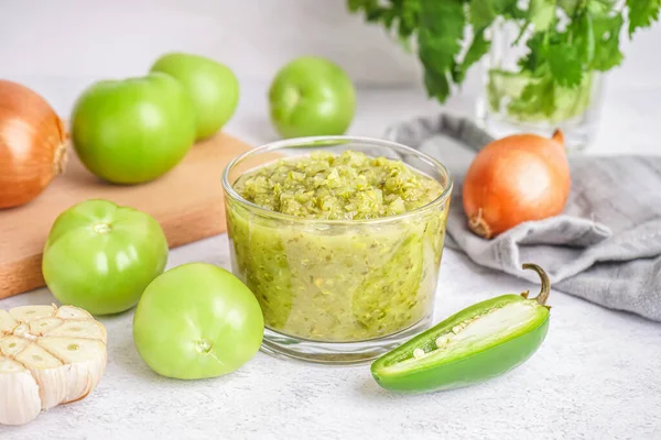Glass Bowl Tasty Green Salsa Sauce Tomatoes Light Background — Stock Photo, Image