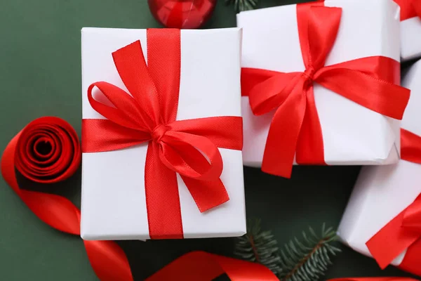 Christmas Gifts Tied Red Ribbon Green Background Closeup — Stock Photo, Image