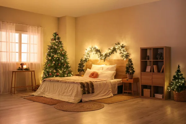 輝くクリスマスツリーとモミの枝と寝室のインテリア — ストック写真