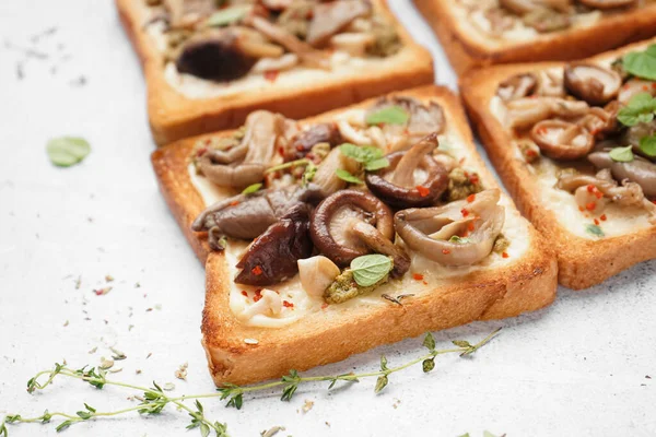 stock image Delicious toasts with cream cheese, mushrooms and pesto sauce on light background, closeup