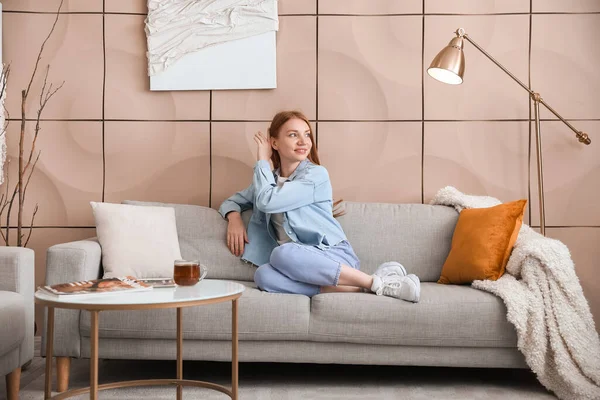 Beautiful Woman Sitting Grey Sofa Home — Stock Photo, Image