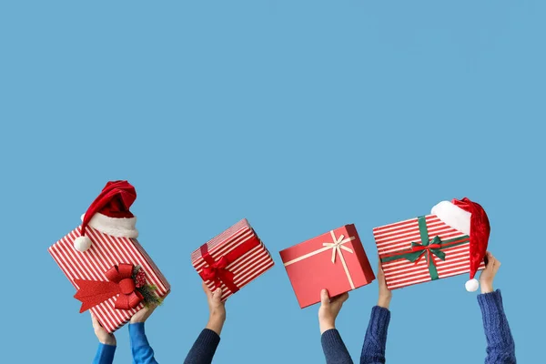 stock image People with Christmas presents on blue background