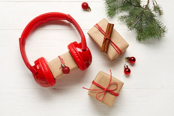 Modern Headphones Christmas Gifts Balls Fir Branch Light Wooden Background — Stock Photo, Image