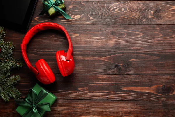 Modern Headphones Christmas Gifts Fir Branches Wooden Background — Stock Photo, Image