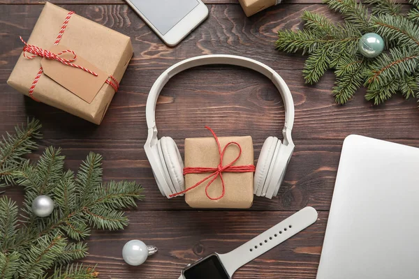 Composition Modern Headphones Wrist Watch Christmas Gifts Fir Branches Wooden — Stock Photo, Image