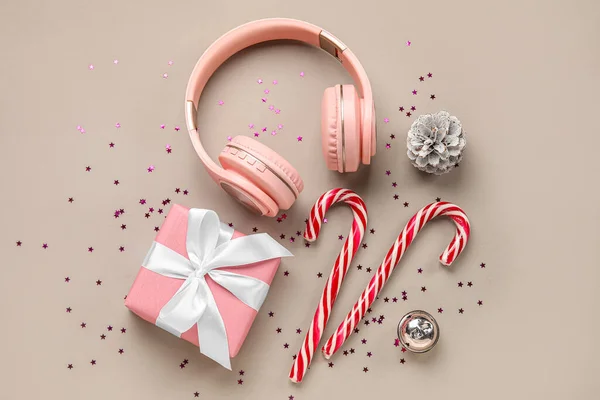 Composition Modern Headphones Christmas Gift Candy Canes Sequins Color Background — Stock Photo, Image