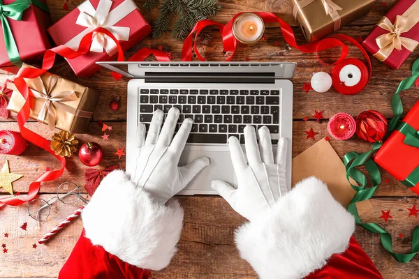 Santa Claus Using Laptop Wooden Table Christmas Decor Gifts Top — Stock Photo, Image
