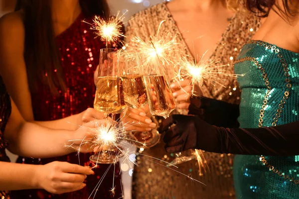 Young Women Elegant Dresses Glasses Champagne Burning Christmas Sparklers Closeup — Stock Photo, Image
