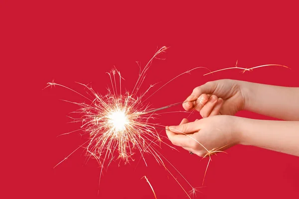 Female Hands Burning Christmas Sparklers Color Background — Stock Photo, Image