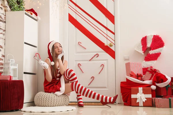 Young Woman Santa Costume Candy Canes Sitting White Door Christmas — Stock Photo, Image