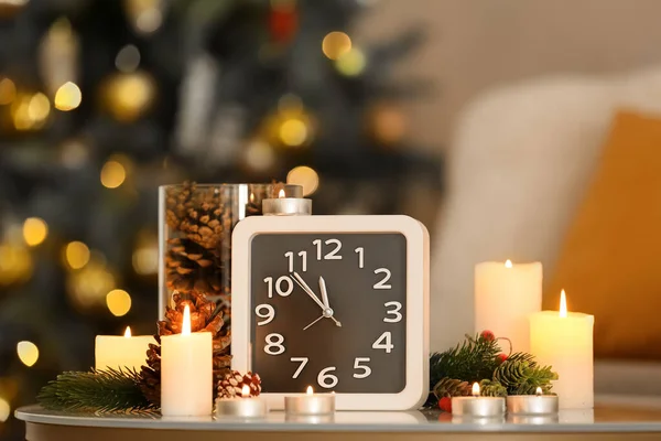 Clock Burning Candles Christmas Branches Fir Cones Table Blurred Lights — Stock Photo, Image