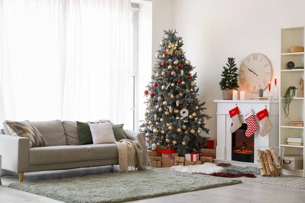 Interior of living room with big clock, fireplace and Christmas trees