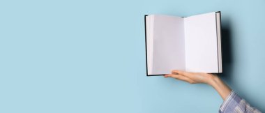 Açık mavi arkaplan ve metin için alanı olan boş bir kitap.