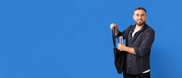 Young Man Putting Books Bag Blue Background Space Text — Stock Photo, Image