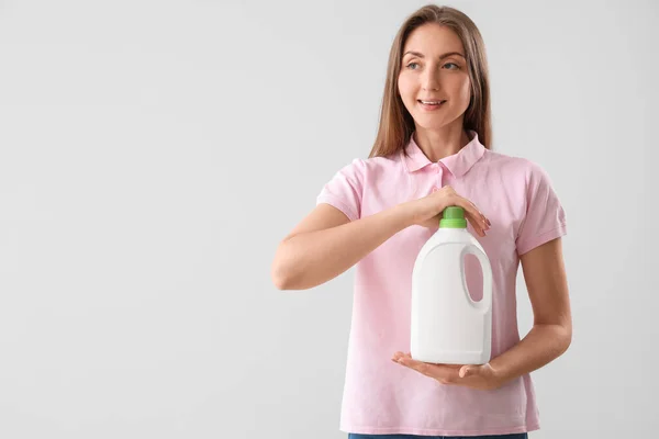 Young Woman Bottle Detergent Light Background — Stock Photo, Image