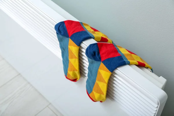 Warm Socks Drying Electric Radiator Light Wall Closeup — Stock Photo, Image