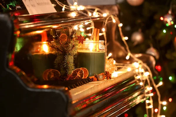 Burning Candle Christmas Treats Decor Glowing Lights Piano Keys Closeup — Stock Photo, Image